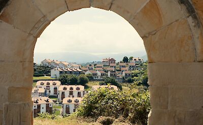 Looking through an arch in San Vicente de la Barquera, Spain. Unsplash:Victor Hugo