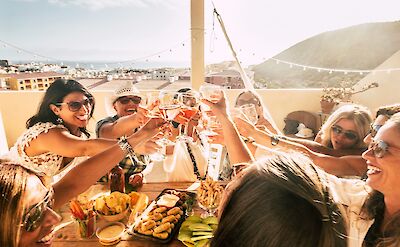 Women clinking glasses, Spain. Unsplash:Getty Images