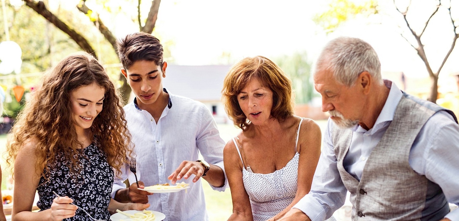 A family enjoying an outdoor meal. Unsplash@Getty Images