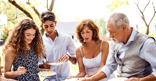 A family enjoying an outdoor meal. Unsplash@Getty Images