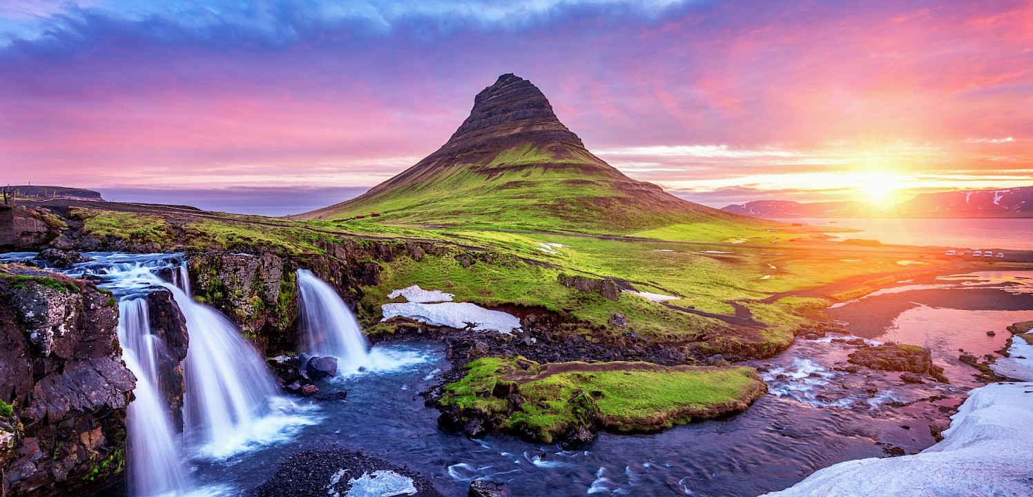 A sunset image of waterfalls and a hill. Unsplash@Getty Images