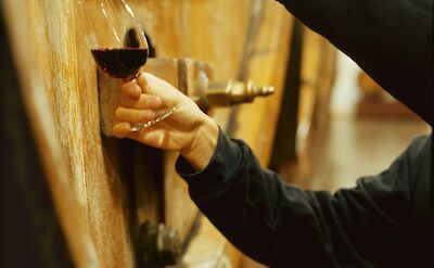 Getting Portuguese wine from a barrel. Unsplash@Getty Images