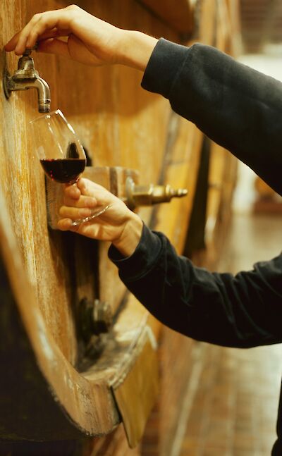 Getting Portuguese wine from a barrel. Unsplash@Getty Images