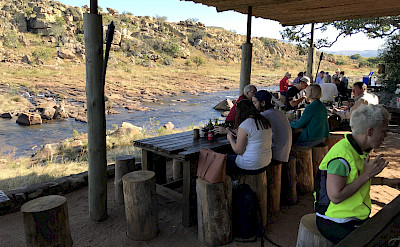 Enjoying a riverside lunch during this great South African bike tour!