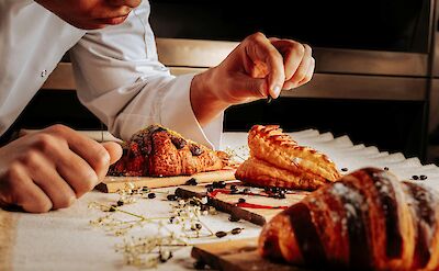 Chef decorating croissants, France. Unsplash:Getty Images