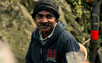 Local man in Munnar, Kerala bike tour, India. Unsplash@Godwin Babu