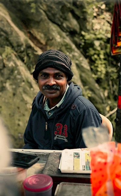 Local man in Munnar, Kerala bike tour, India. Unsplash@Godwin Babu