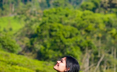 Smiling in the tea plantations, Vagamon, Kerala bike tour, India. Unsplash@Anas Anwar