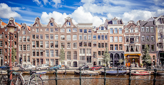 Gorgeous facades and canals in Amsterdam, North Holland, the Netherlands. Photo via Flickr:Andres Nieto Porras