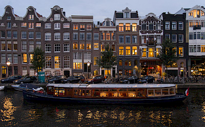 Amsterdam aglow at night with its many canals, North Holland, the Netherlands. Photo via Flickr:BriYYZ