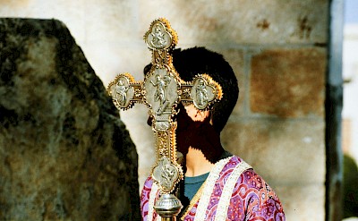 A man holding an ornate cross in Madaba, Jordan. Unsplash@Georg Arthur Pflueger