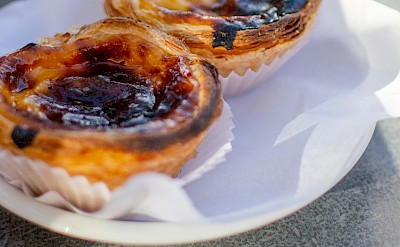Plate of fresh pasteis de nata, Portugal. Unsplash@Hector John Periquin