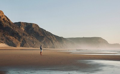 Standing on the beach in Sagres, Portugal. Unsplash@Leon Rohrwild