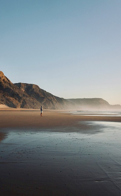 Standing on the beach in Sagres, Portugal. Unsplash@Leon Rohrwild