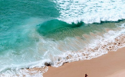 Woman standing on the beach, Sagres, Portugal. Unsplash@Micaela Parente