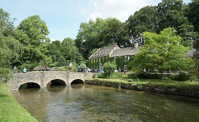 A bridge over a river in the Cotswolds, England. Unsplash:Uniq Trek