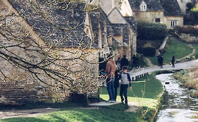 Walking alongside a stream, Cotswolds, England. Unsplash:Sarthaak Maji