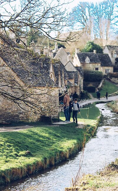 Walking alongside a stream, Cotswolds, England. Unsplash:Sarthaak Maji