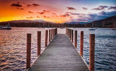 Boardwalk over Lake Windermere at sunset, Lake District, England. Unsplash:claire jones