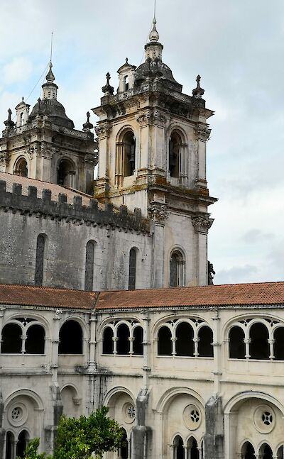Arched cloisters of the Alcobaça Monastery in Portugal. Unsplash@Antonio Sessa