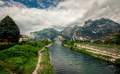 Cycling along the path in Riva del Garda, Italy. Flickr:waldemarmerger