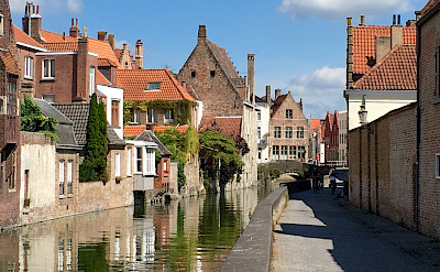 Biking along the canal in Bruges, Belgium. Photo by Regina Losinger