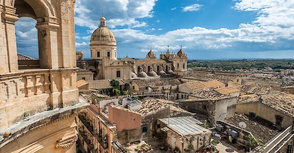View over the rooftops of Noto toward the Cathedral of San Nicol&ograve;. Flickr:MichaelGaylard