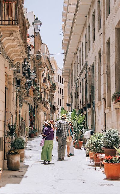 A charming lane lined with Baroque balconies in Syracuse. unsplash:YoavAzize9