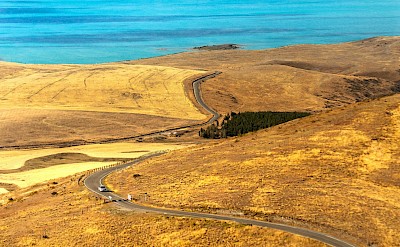 Winding road to Lake Tekapo, New Zealand. Unsplash@Marek Piwnicki