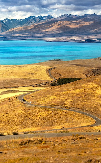 Winding road to Lake Tekapo, New Zealand. Unsplash@Marek Piwnicki