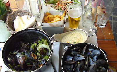 Moules frites with beer in Belgium. Flickr:E and JS Film Crew