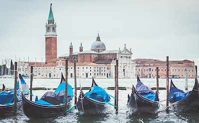Gondolas await to explore San Marco Square in Venice, Veneto, Italy. Photo via TO