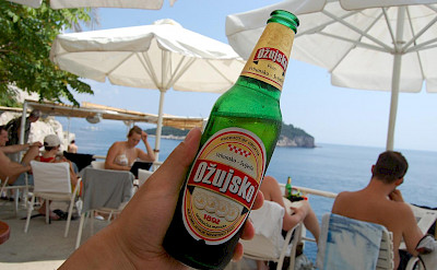 Enjoying a local beer from Cafe Bar Buza in Dubrovnik, Croatia. Flickr:Yusuke Kawasaki