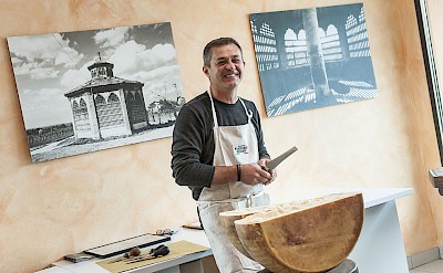 Cheesemaker explaining the production process. to-BTP