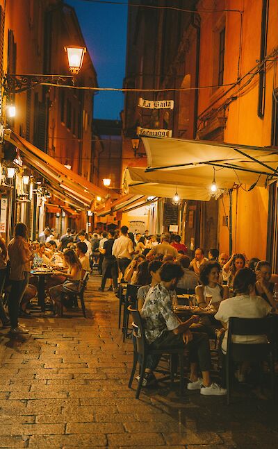 Restaurants in Bologna at night, Italy. Unsplash@Caroline Roose