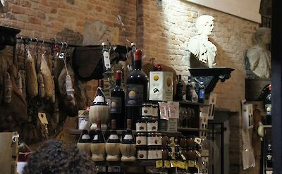 Wine and ham in a shop in Parma, Italy. Unsplash@Kalina O
