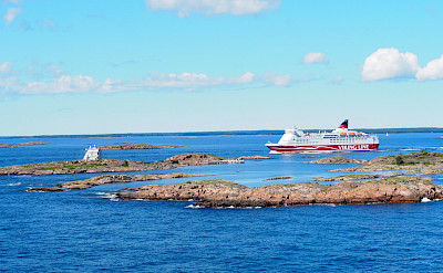 Cycling to the Aland Islands. Cruise ship passing Koppa Klintar near Mariehamn, Finland.