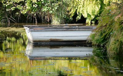 Boat on a river in Kent, England. Unsplash:Steve Payne