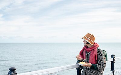 Eating fish and chips by the sea. Unsplash:Laura Adai