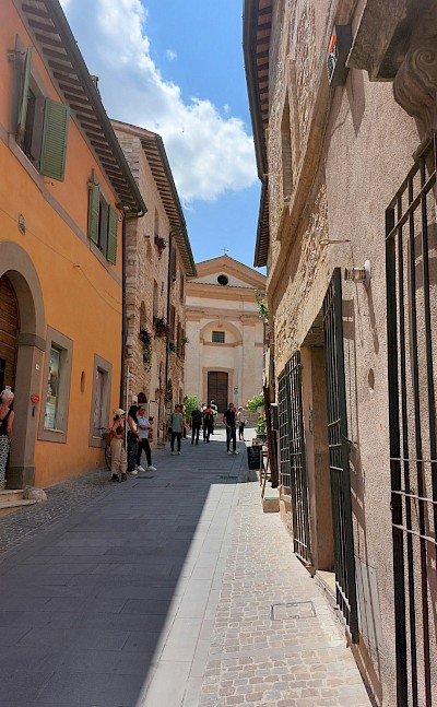 Orange building in Spello, Umbria walking tour, Italy. Unsplash@Csilla Monica Slezsak