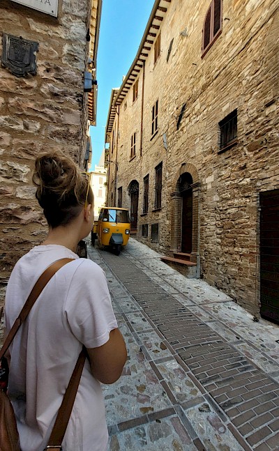 Waiting for a tuk tuk to pass in Spello, Italy. Unsplash@Luca Fantini