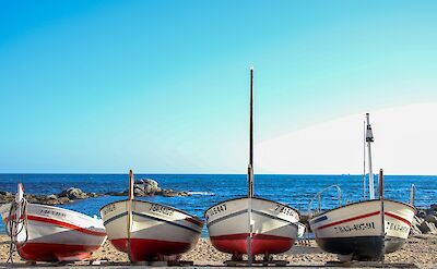 Boats in a row at Calella de Palafrugell, Catalonia. Unsplash@Ferran Buireu